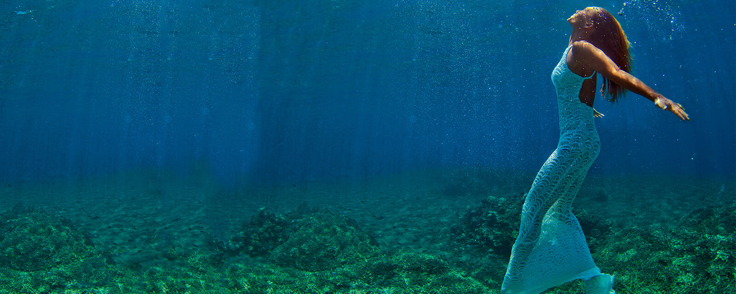 Kim on ocean floor in translucent blue dress