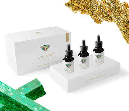 Anami Alchemia Crystal Elixir Psychedelic Menopause collection of three bottles in branded white packaging against a plain white background. 