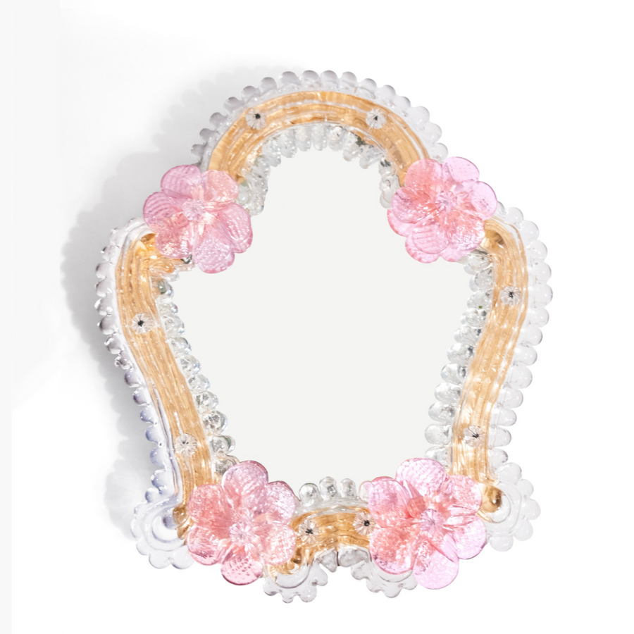 A frontal view of Anami Alchemia's ornate yoni viewing mirror in blush colour way, against a plain white background. 