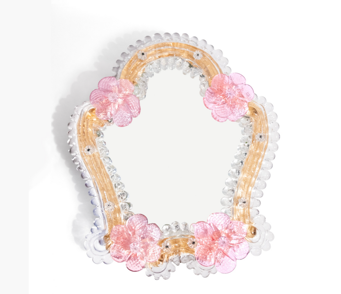 A frontal view of Anami Alchemia's ornate yoni viewing mirror in blush colour way, against a plain white background. 