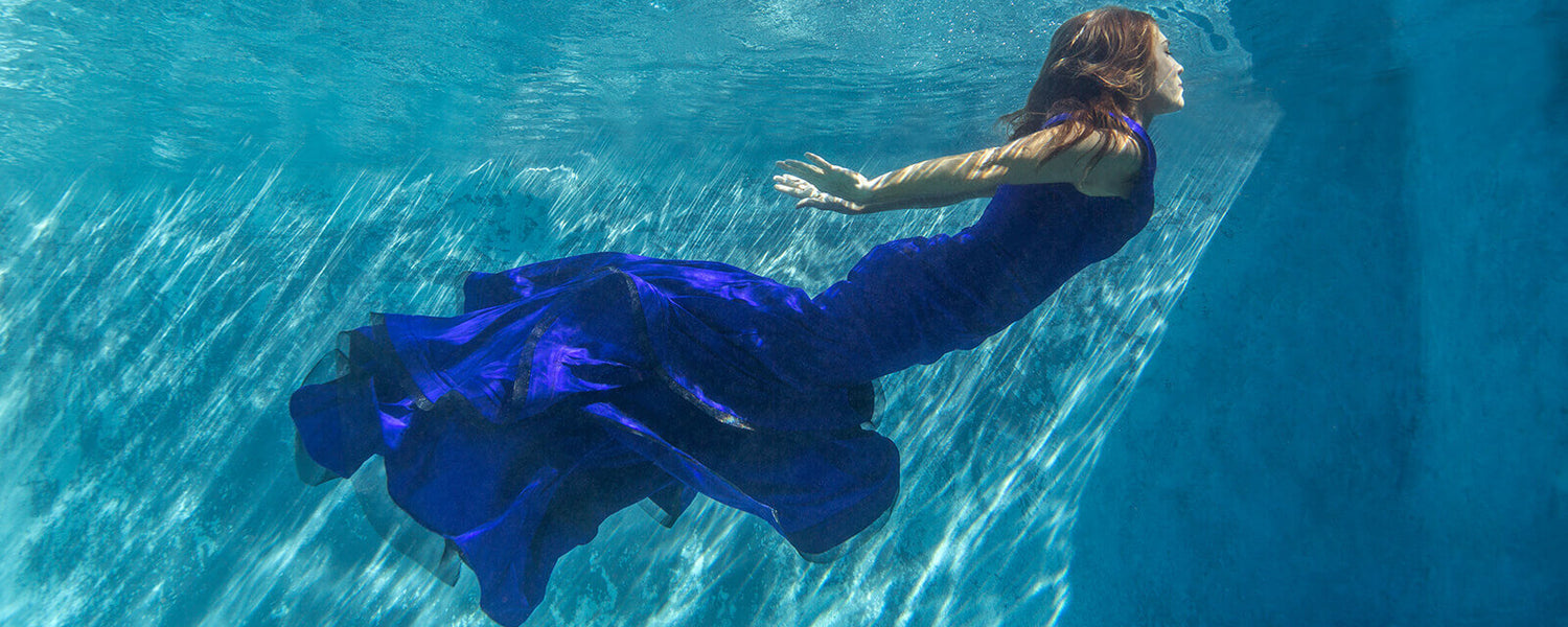 Kim underwater in blue dress